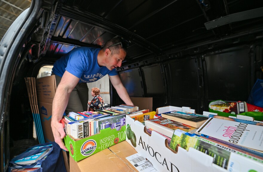 Derek Felsman unloads books as part of the Leadership Northeast group New Books on the Block at the Luzerne County Correctional Facility.