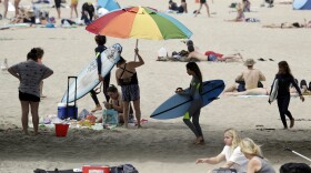 On Thursday, beachgoers flocked to Huntington Beach. Calif. Gov. Newsom announced that same day he was ordering all Orange County beaches to close, after tens of thousands gathered at the shore last weekend.