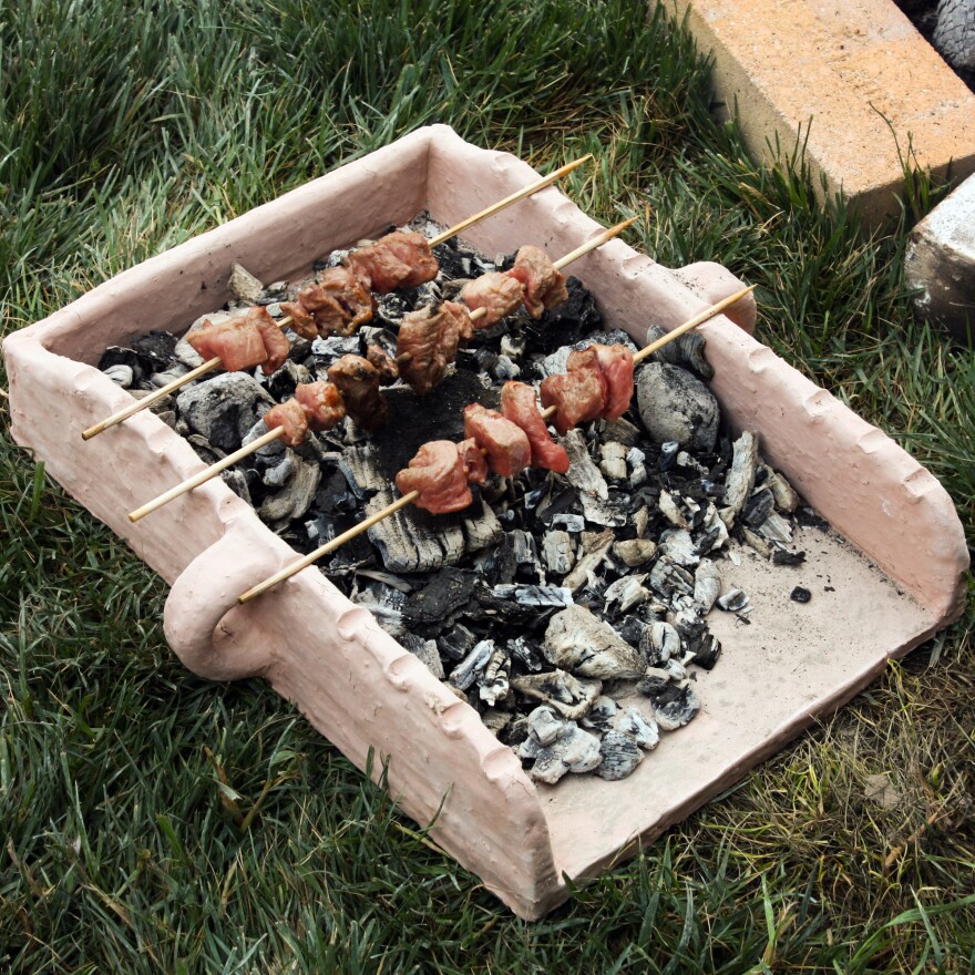 Souvlaki skewers in a replica of a tray the Mycenaeans used to prepare their food in ancient Greece.