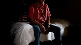 George Crooks sits on the edge of his bed in Oklahoma City where he awoke to police who had come to take him to the hospital, again.