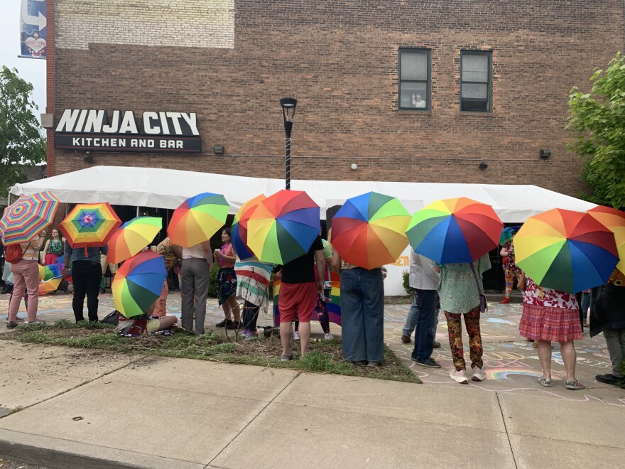 The umbrellas acted as a visual barrier between theater-goers and protesters.