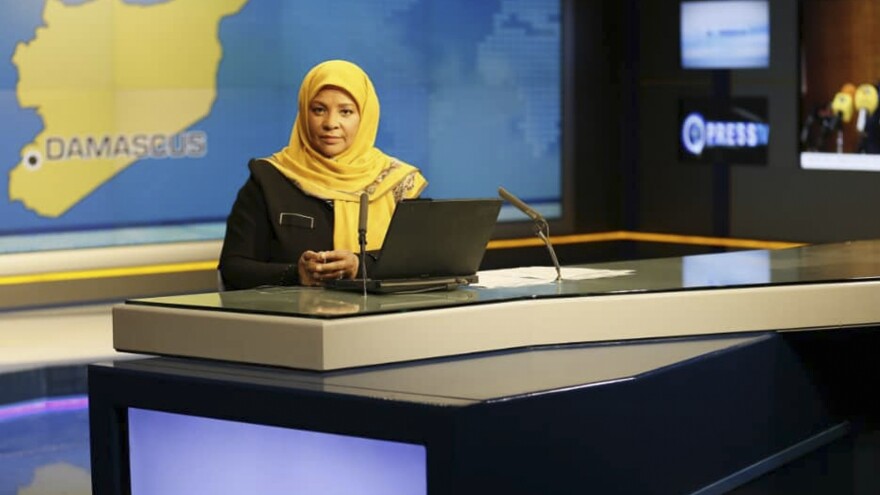 American-born news anchor Marzieh Hashemi sits in a studio in Tehran where she works for Iran's state television. She was arrested Sunday during a visit to the U.S., her family says. She is testifying behind closed doors to a grand jury in Washington, D.C., in an unspecified case, a U.S. judge said Friday.