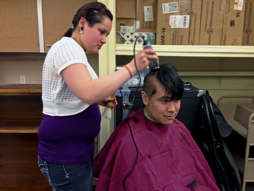 KLA student Theresa Corp buzzes her classmate David Evon's hair in support KLA teacher, Connie Sankwich. Photo by Angela Denning Barnes, KYUK - Bethel.