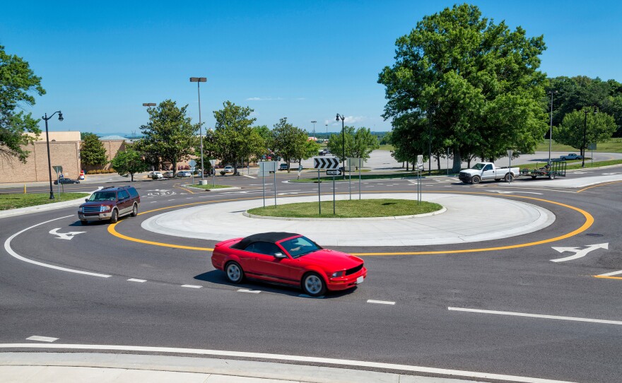 Physical solutions to reduce speeding include traffic circles, as seen in the image, speed tables, and speed humps.