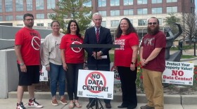 Festus residents stand around the attorney representing their case, Steve Jeffery, at a press conference Thursday announcing their suit against the city and data center developer CRG.