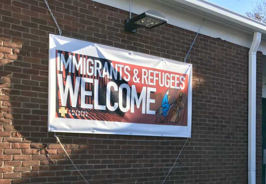 A sign welcoming immigrants and refugees. [M.L. SCHULTZE / WKSU]