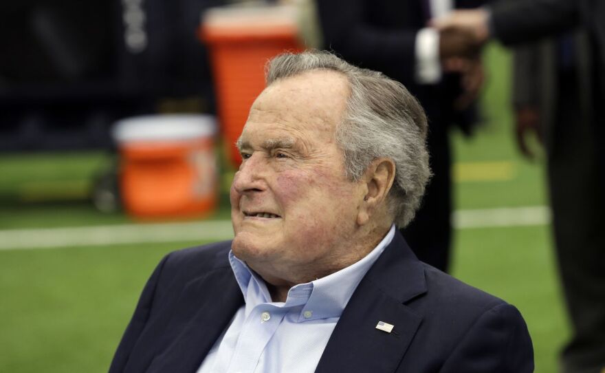 FILE- In this Nov. 5, 2017, file photo, former president George H.W. Bush arrives for an NFL football game between the Houston Texans and the Indianapolis Colts in Houston. 