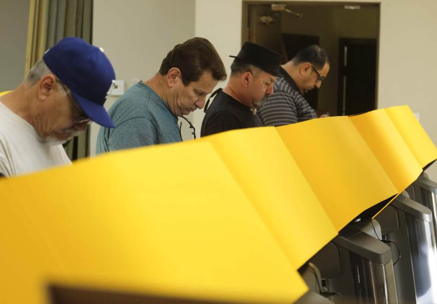 Voters cast their ballot on the Super Tuesday, at a voting center in Rosemead, Calif., Tuesday, March 3, 2020.
