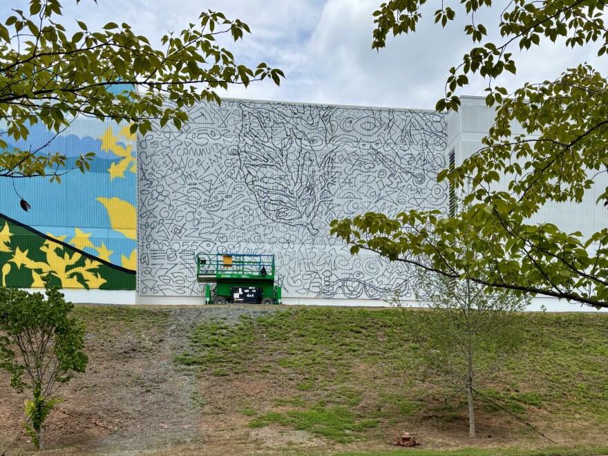 A half painted mural featuring a doodle grid