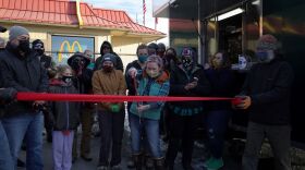 Diane Million cuts the ribbon for her new food truck business.