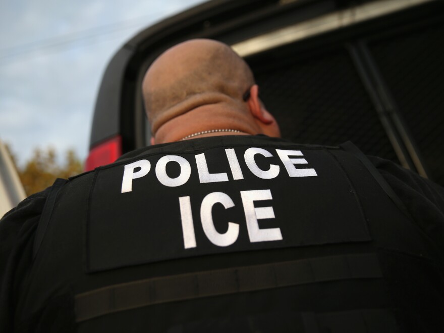U.S. Immigration and Customs Enforcement agents detain an immigrant on Oct. 14, 2015, in Los Angeles.