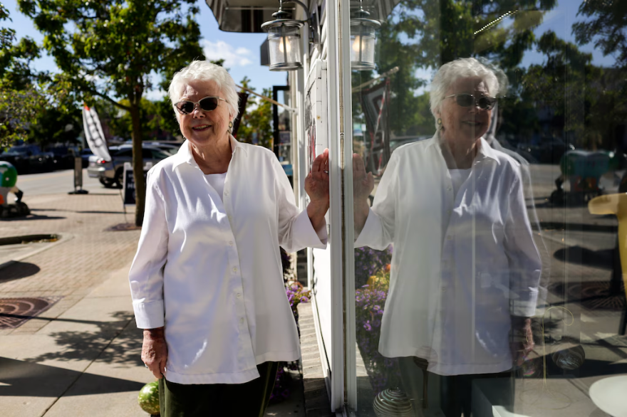 Mullaly’s 128 Gallery owner Barb Mullaly poses for a portrait outside of the gallery on Friday, Oct. 9, 2026, in Elk Rapids. Mullaly is one of more than 1,600 voters whose status was questioned. (Photo: Kristen Norman for Votebeat)