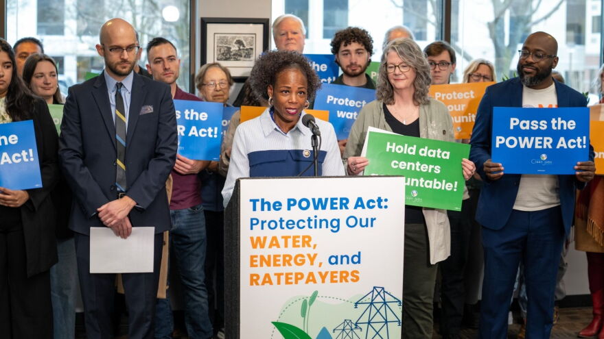 Illinois Rep. Carol Ammons, at the podium, speaks at a POWER Act press conference in Champaign, Illinois, on Feb. 17, 2026.