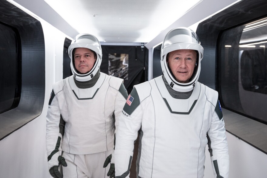 NASA astronauts Bob Behnken (left) and Doug Hurley will have to wait until the weekend, at the earliest, to lift off from NASA's Kennedy Space Flight Center in Florida.