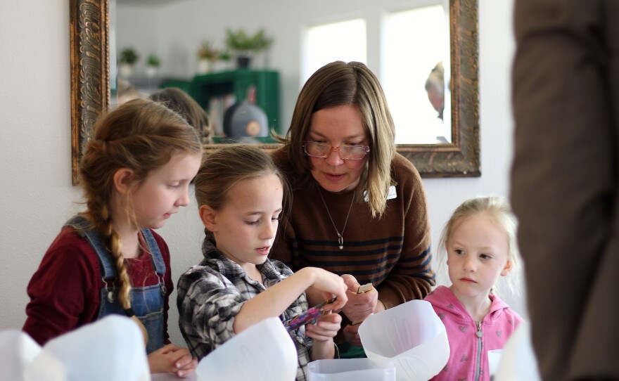 Ella Kerner, branch lead for Hunters and Colville libraries, helps young learners with their mini greenhouses. The rural library is one of seven at risk of facing service and hour cuts if an operations levy doesn’t pass this April.