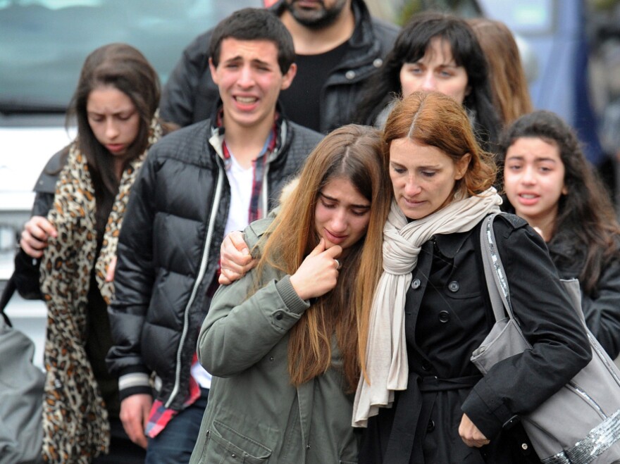 Young people walk away from the Ozar Hatorah Jewish school, on Monday in Toulouse, southwestern France, where at least four people (three of them children) were killed and one seriously wounded when a gunman opened fire. It was the third gun attack in a week by a man who fled on a motorbike. 