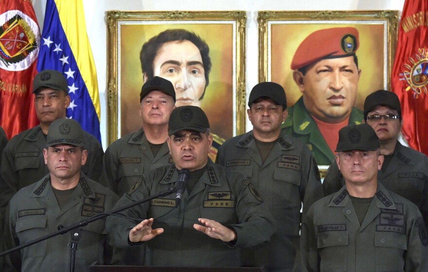Venezuelan Defense Minister Vladimir Padrino delivers a speech while surrounded by military men in Caracas on Tuesday. Padrino reiterated the military's "unrestricted obedience, subordination and loyalty" to President Nicolás Maduro.