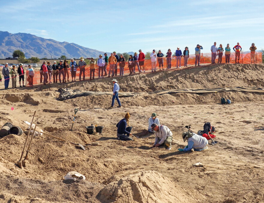 Pima County Historic Preservation Officer Ian Milliken speaks to a crowd at the Sunset Road archaeological site during a public viewing event in 2016.