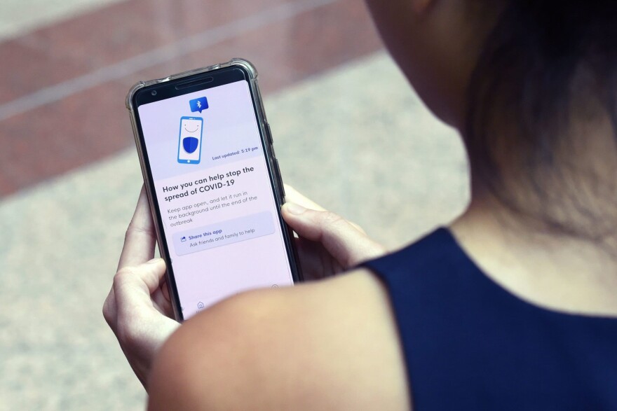 A Government Technology Agency staff member demonstrates Singapore's new contact-tracing smartphone app called TraceTogether, as a preventive measure against COVID-19 coronavirus in Singapore. (Catherine Lai/AFP/Getty Images)