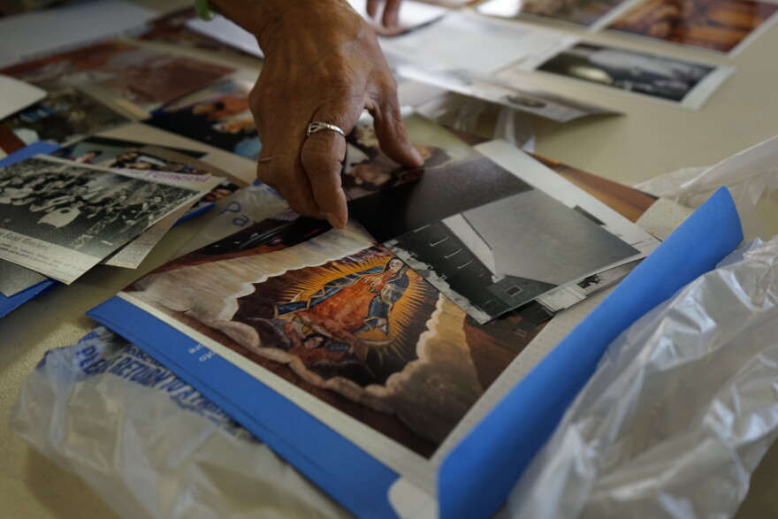 Lydia Anaya sorts through photographs in the basement of Our Lady of Guadalupe in Flagstaff, Ariz., in March 2026.