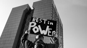 A person holds a Rest In Power sign outside the Hennepin County Courthouse in downtown Minneapolis, Minnesota as the trial of former Minneapolis police officer Derek Chauvin began on March 8.
