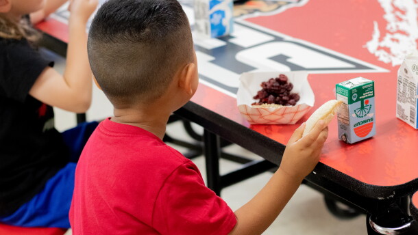 A pre-kindergarten student eats a peanut butter and jelly sandwich during "third meal" at Whitebead Public Schools.