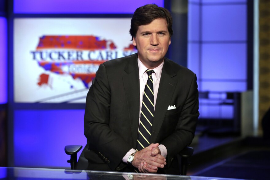 In this March 2, 2017 file photo, Tucker Carlson, host of "Tucker Carlson Tonight," poses for photos in a Fox News Channel studio, in New York. (AP Photo/Richard Drew, File)