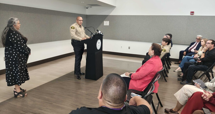 Bernalillo County Commission Chair Adriann Barboa, left, looks on as Bernalillo County Sheriff John Allen addresses those who attended a press conference on Wednesday announcing the proposed declaration, which will be aimed at expanding revocery services and treatment options.