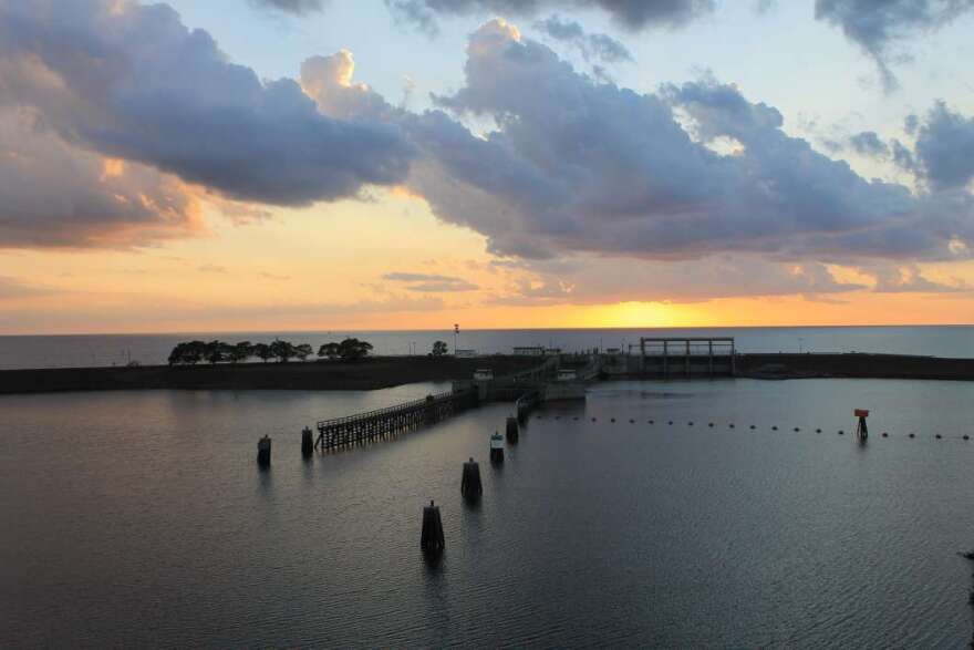 The sun sets behind the lock and dam on Lake Okeechobee and St. Lucie Canal. 