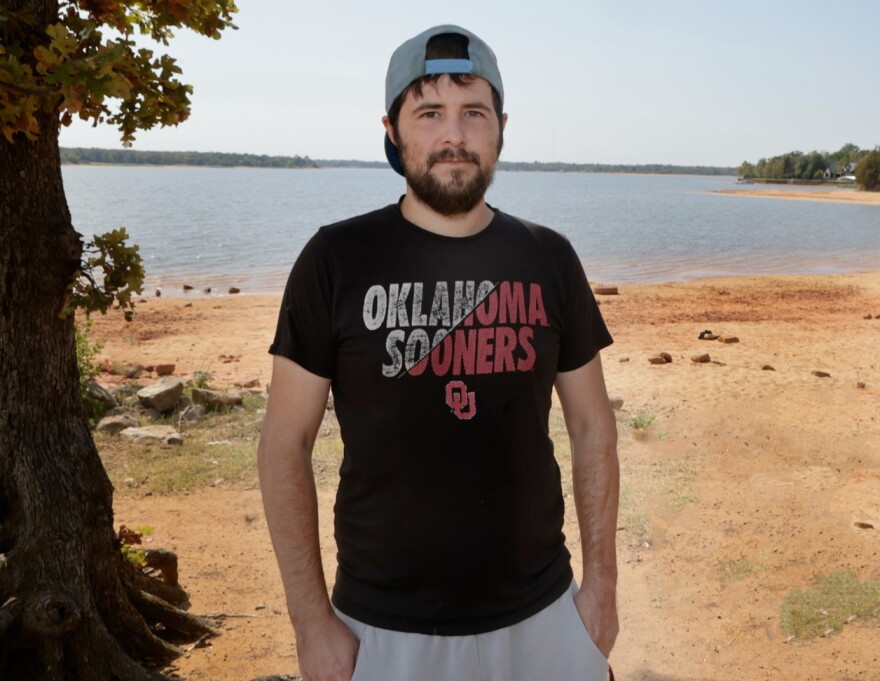 Damien O’Daniel pauses for a photo at a park in Shawnee. O’Daniel received a third-degree burn in an industrial accident at a Logan County marijuana processing plant.