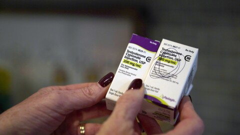 AP file - Becky Hormuth holds boxes containing testosterone Wednesday, Sept. 20, 2023, in Wentzville, Mo.