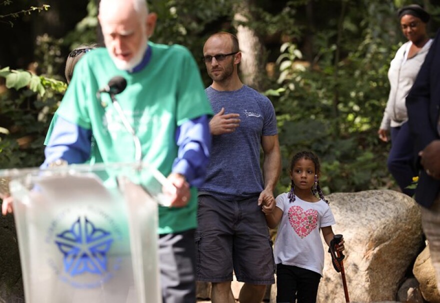 Robert Allen and his daughter, Kaylee Allen, stumble into a press conference after hiking in Washington Grove.