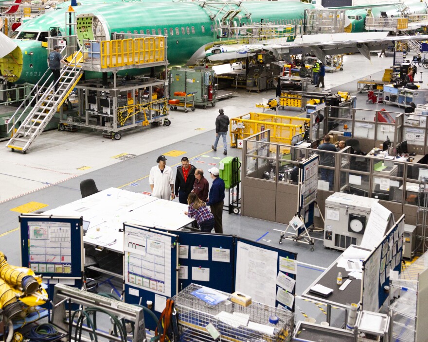Teams of airplane designers and engineers work in cubicles or at tables just to the side of the production lines, allowing them to check on progress and troubleshoot problems as they come up.