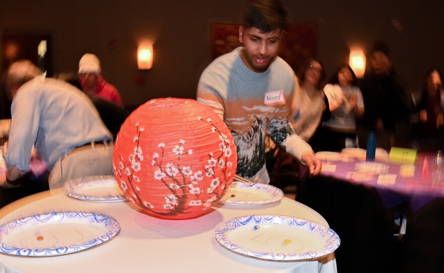 University of Scranton students play a game moving M&Ms using chopsticks.