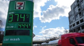 Fuel prices are displayed on a sign at a gas station as a fuel truck drives by, March 17, 2026, in Baltimore. (AP Photo/Stephanie Scarbrough, File)