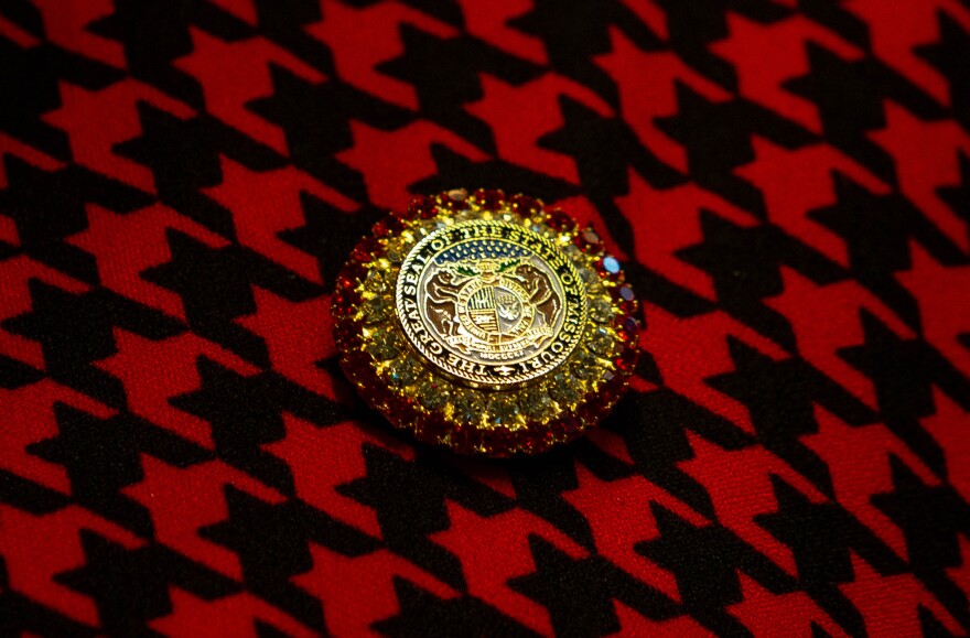 A Missouri representative wears a jewel-encrusted brooch with the state seal on Wednesday during the first day of the legislative session. 
