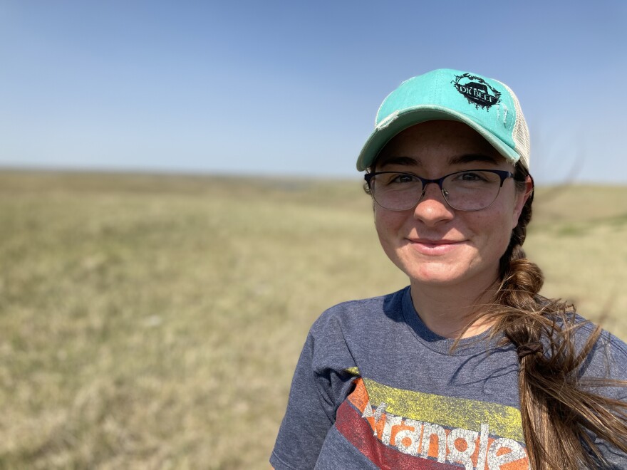 Kelsey Scott stands in one of the pastures where she grazes her cattle on the Cheyenne River Sioux Reservation.