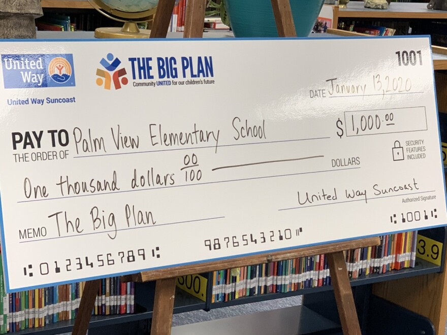 large check for $1,000