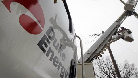 FILE - Duke Energy employees work on power lines in Charlotte, N.C., Feb. 14, 2012. (AP Photo/Chuck Burton, File)