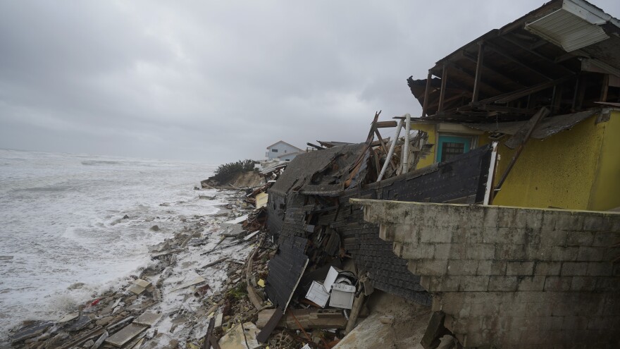 Parts of homes are seen collapsing on the beach due to the storm surge by Hurricane Nicole on Thursday in Wilbur-By-The-Sea, Fla.