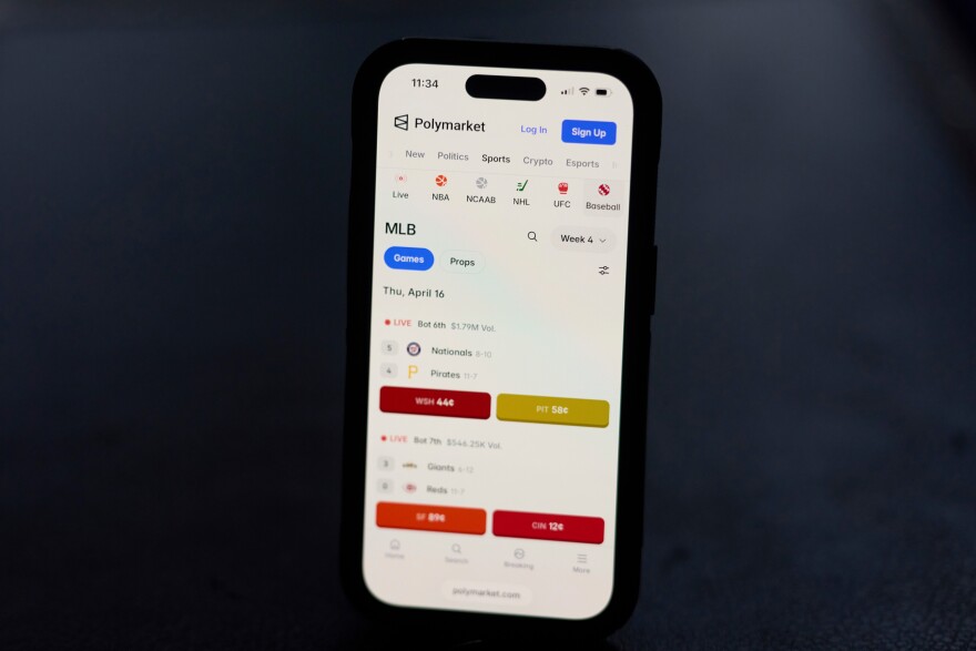A phone displays sports trades on Polymarket on Thursday, April 16, 2026, in Portland, Ore. (AP Photo/Jenny Kane)