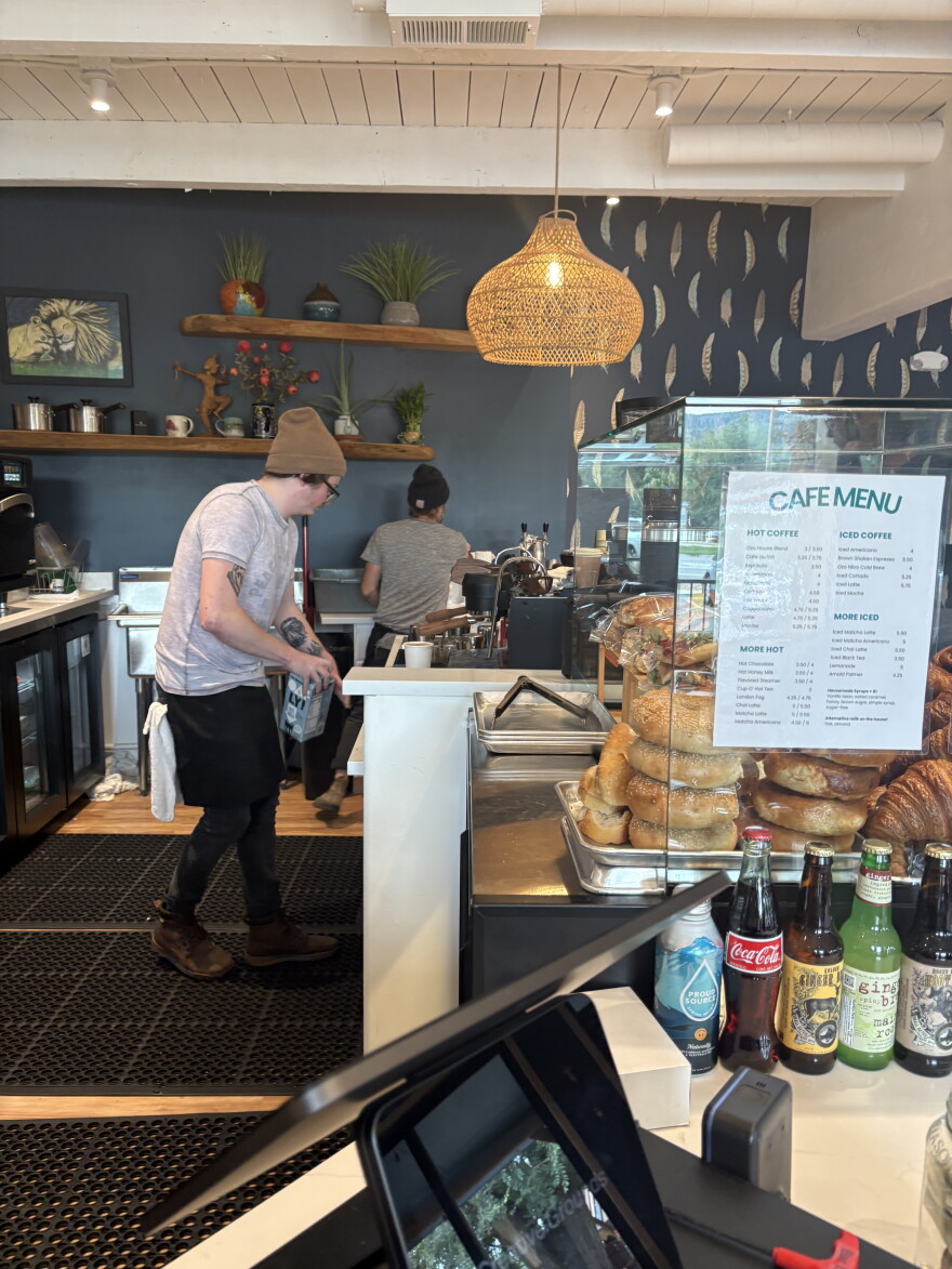Two people work in a coffee shop.