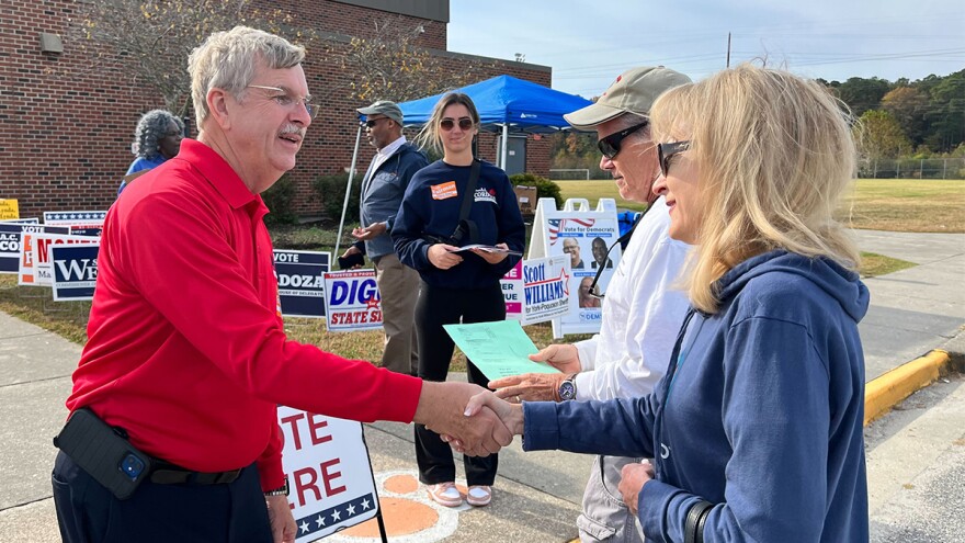 Danny Diggs, left, greets voters at Tabb High School. The former York-Poquoson Sheriff has declared victory in the tight 24th Senate District race. (Photo by Ryan Murphy)