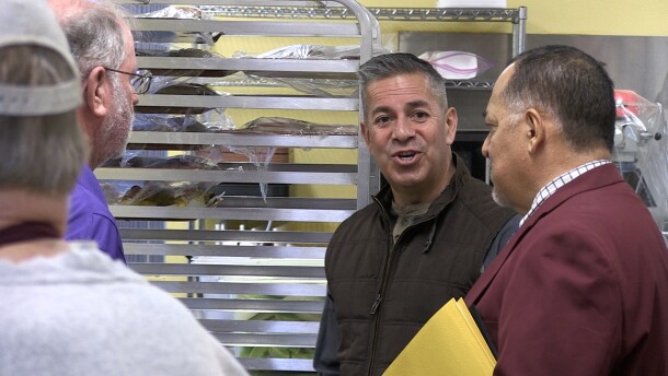 U.S. Senator Ben Ray Luján talking with Steven Chavira at El Caldito Soup Kitchen.