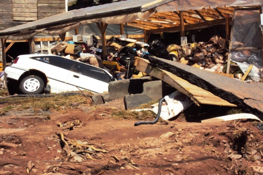 A car sits half-buried after massive flooding swept through downtown Windham, N.Y. from Tropical Storm Irene.