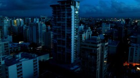 Blacked out buildings are seen in a tourist zone with lights only showing in buildings that have generators in San Juan, Puerto Rico, on Oct. 4, 2017. (Ricardo Arduengo/AFP/Getty Images)