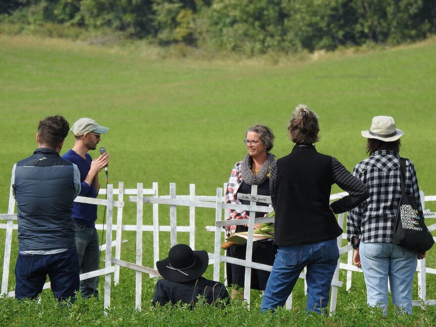 Philip Matthews (left holding microphone) reading poetry as part of artist Catherine Schwalbe’s installation titled “General Sherman’s Footprint” during opening weekend 2022 Farm/Art DTour.