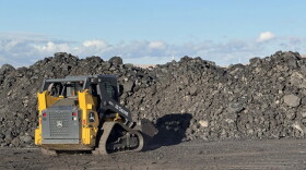 A row of coal next to skid steer inside the Navajo Transitional Energy Company coal yard in New Mexico.
