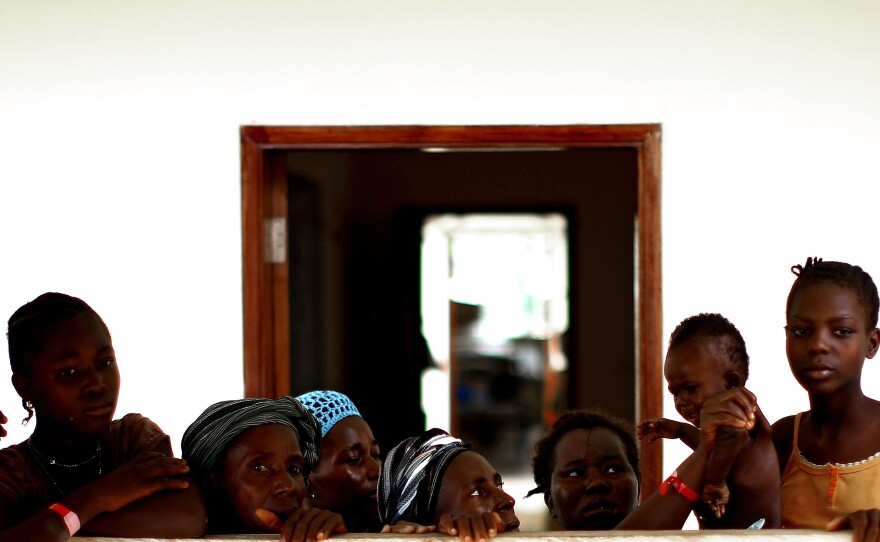 Women and children wait in the recovery area at the Hastings Ebola Treatment Center in Freetown, Sierra Leone. About 60 patients at the facility were almost ready to go home after recovering from Ebola.