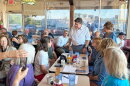 Gov. JB Pritzker speaks to Emily Waugh of Oregon at Lulu’s Diner in Springfield on Thursday, Aug. 27, 2026.